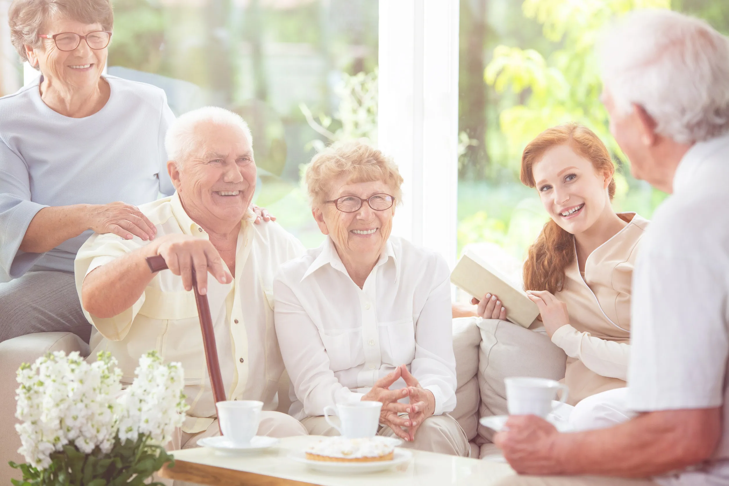 Smiling senior people and happy caregiver drinking tea in the nursing house Smiling senior people and happy caregiver drinking tea in the nursing house