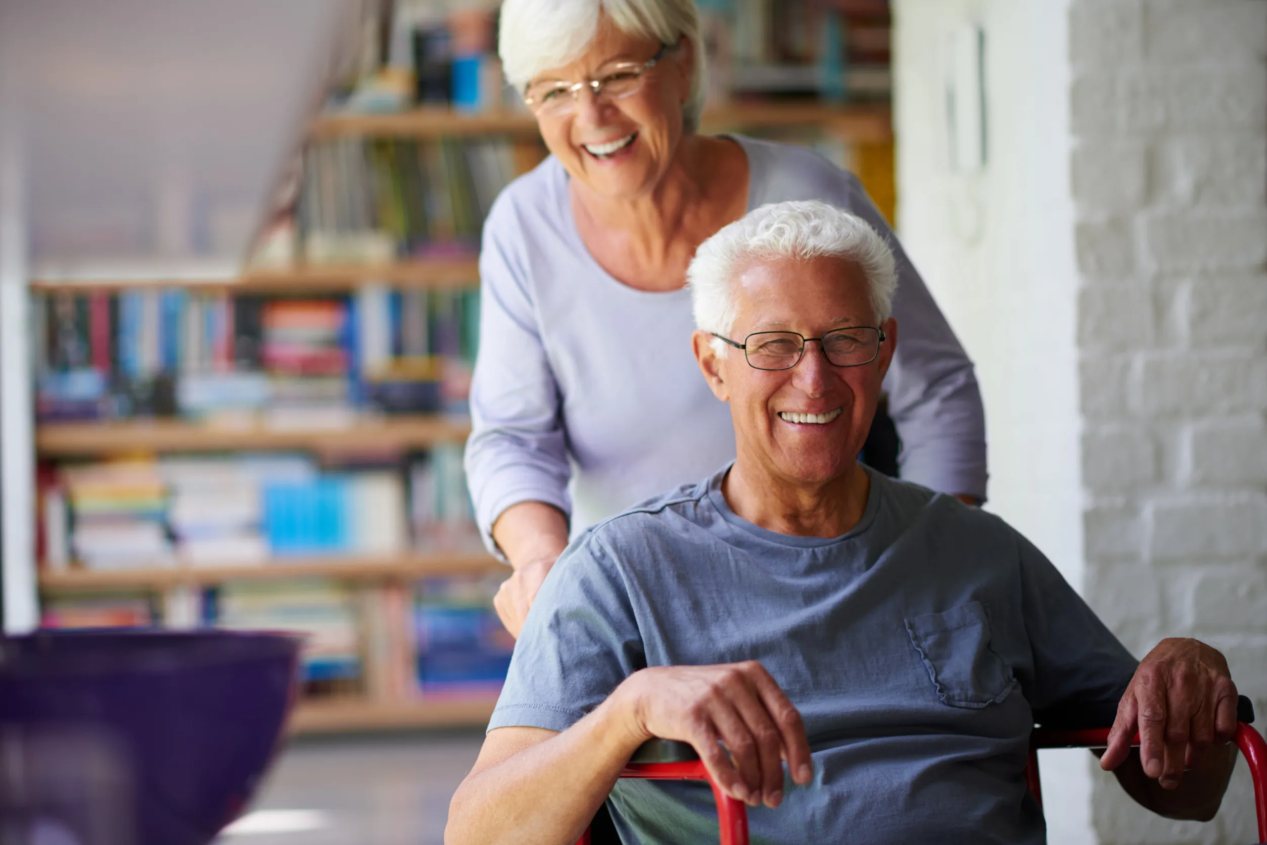 Old-couple-portrait-and-helping-man-in-wheelchair-home-and-support-husband-with-injury Nurse having conversation with african american senior man